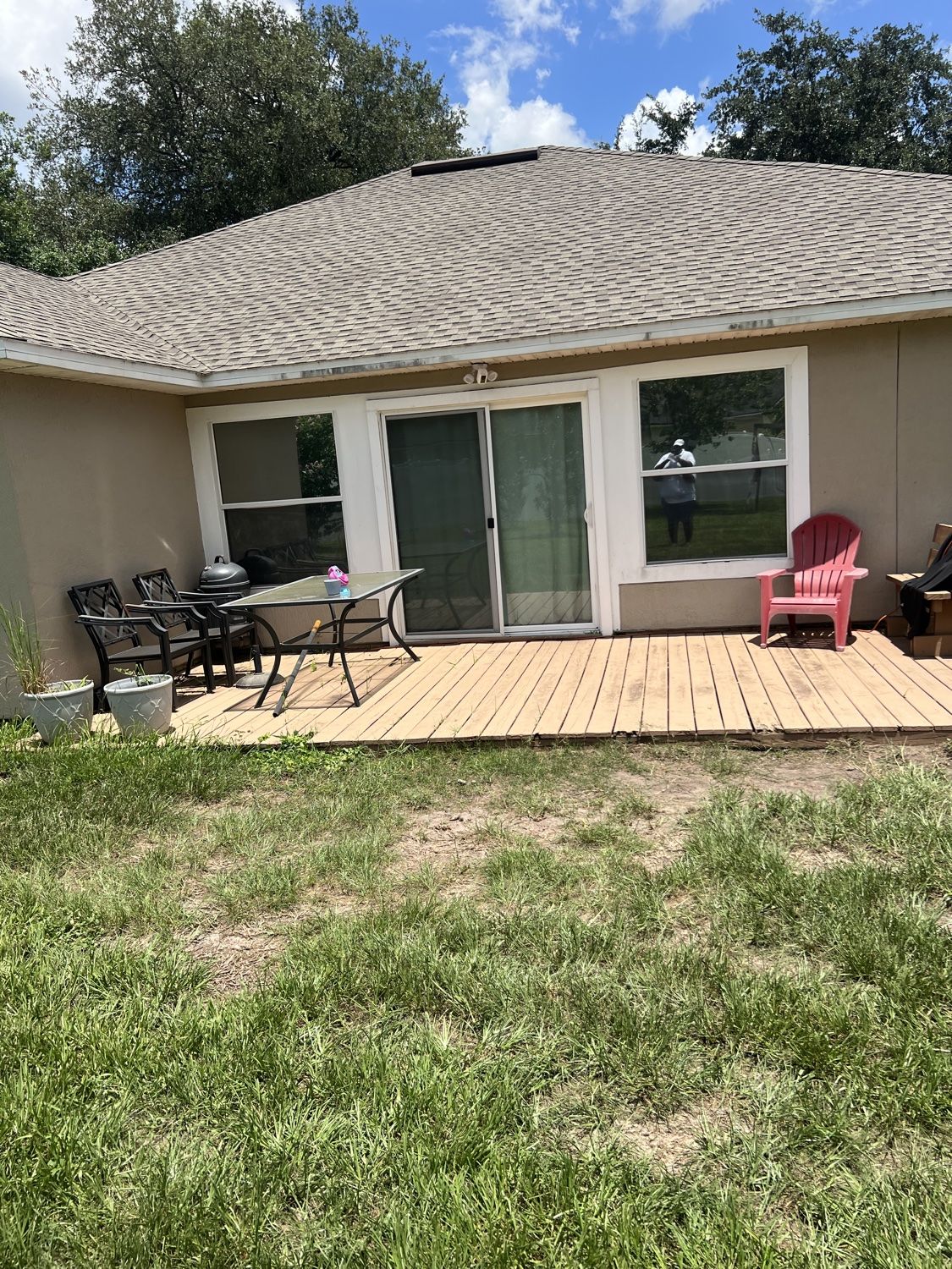 Worn wooden patio deck before paver installation
