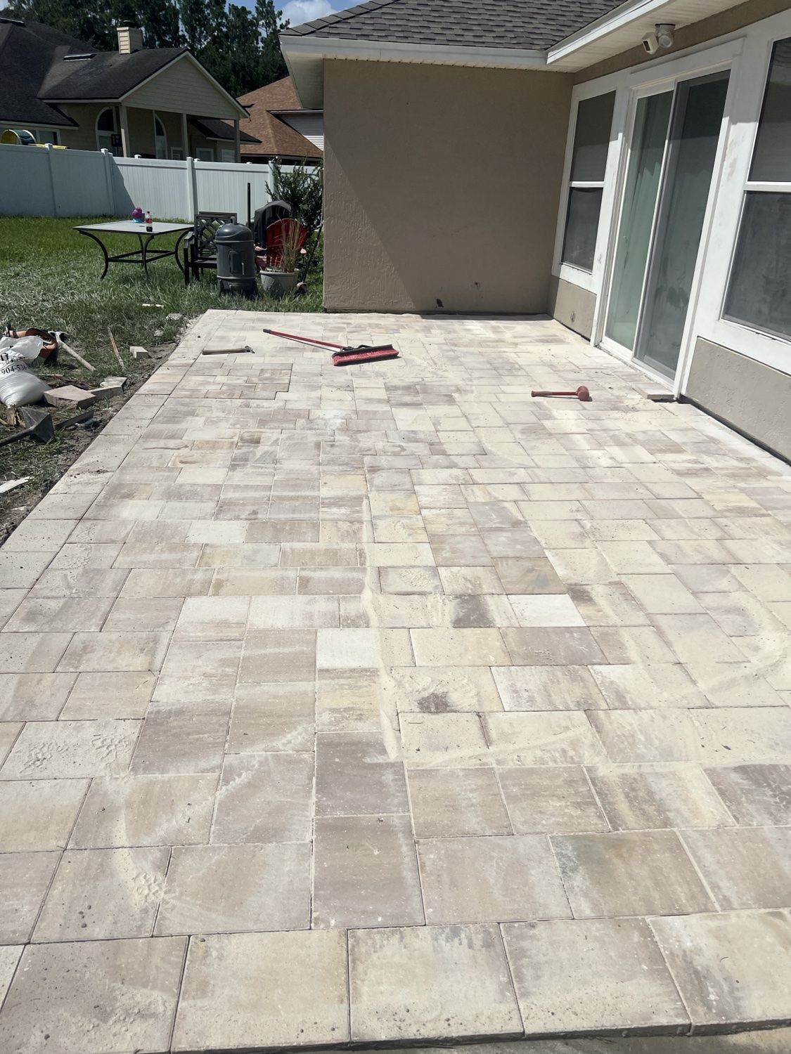 Patio base being screeded and compacted for pavers