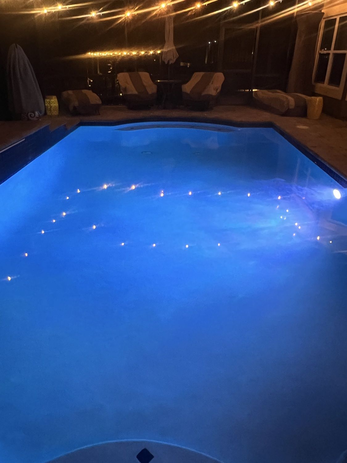 Crystal-clear blue pool beneath a covered outdoor space