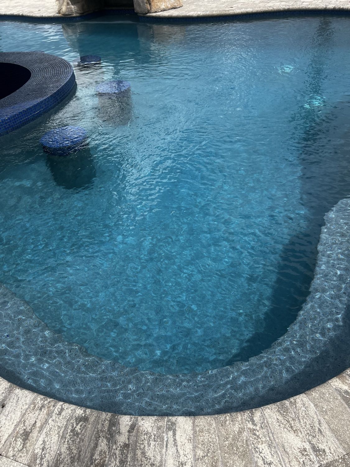 Clean pool water beside swim-up bar seating