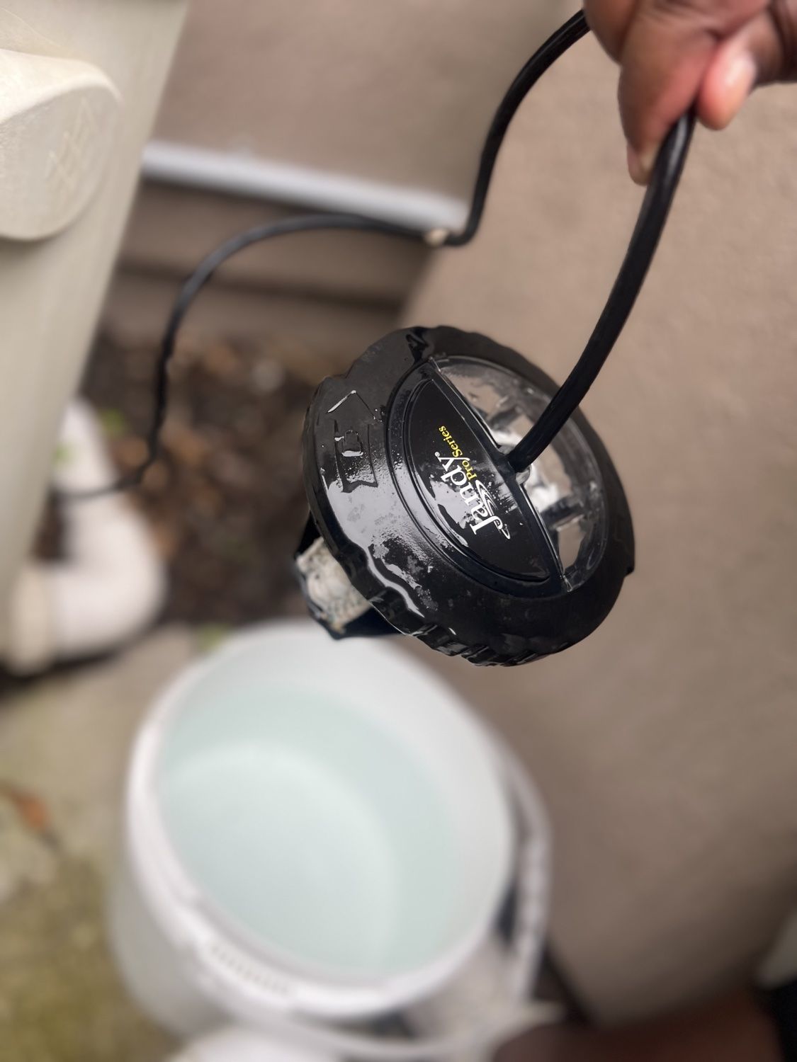 Salt chlorine generator cell removed before cleaning with calcium buildup on the plates