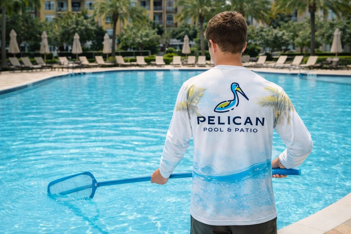 Pelican Pool and Patio technician servicing a clear swimming pool