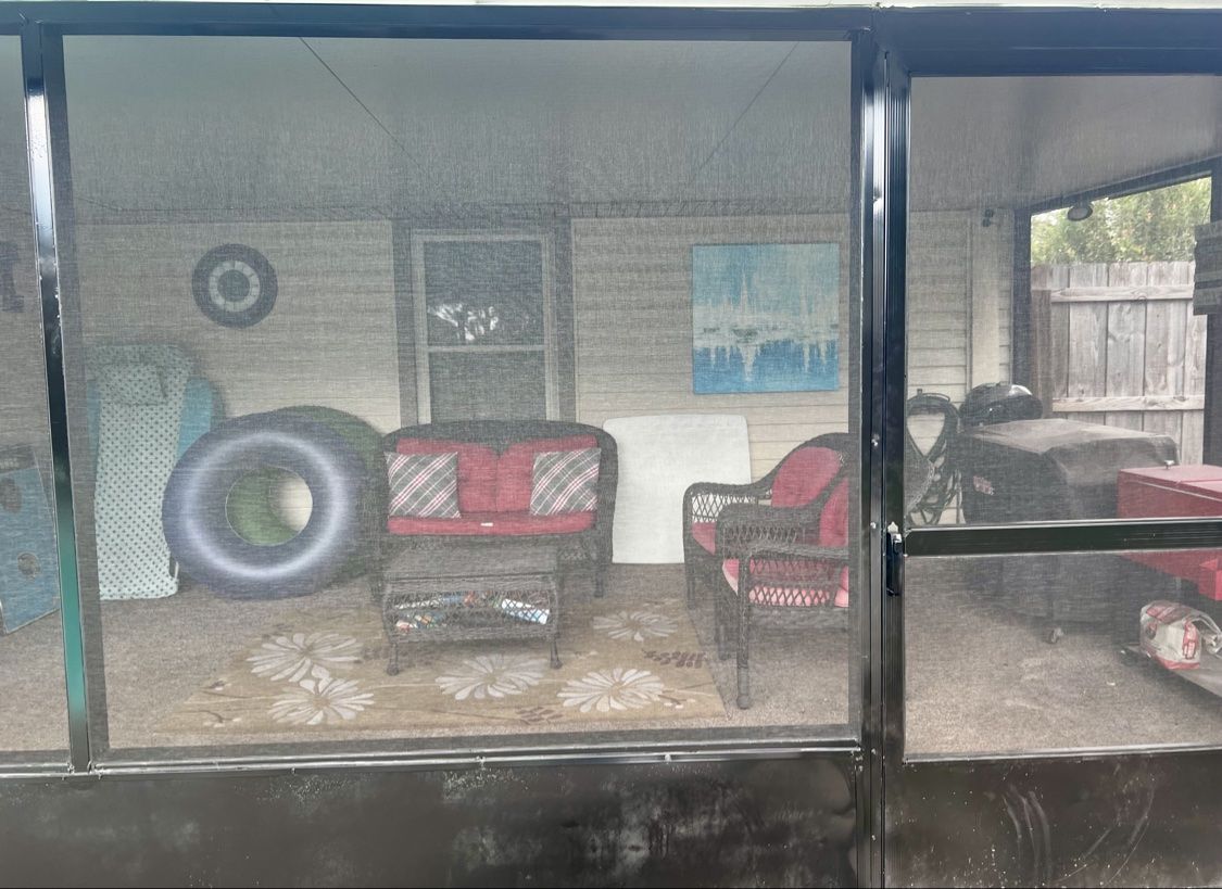 Looking through the finished screen door and new black panels into the patio sitting area