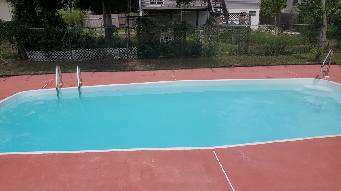 Same rectangular pool with crystal-clear blue water after treatment